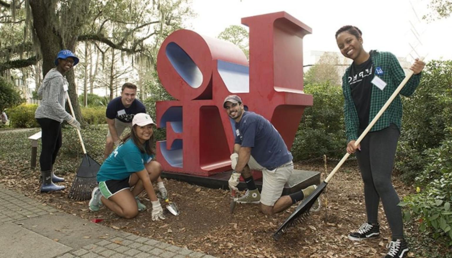 Graduate students  gardening during homecoming week