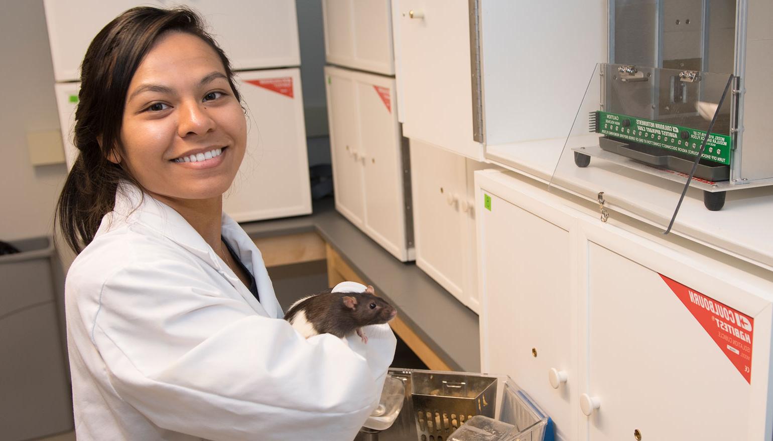 Student in Loyola's Rat Lab 